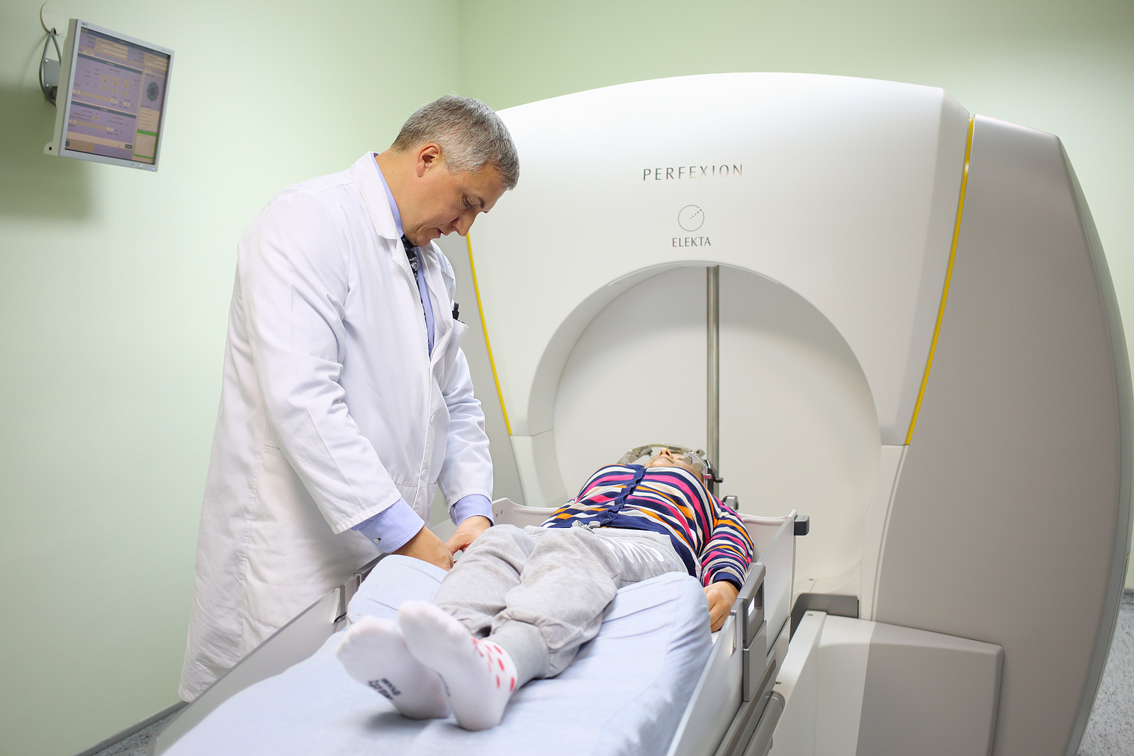 gamma knife radiosurgery - physician prepares patient for the procedure on the Gamma Knife