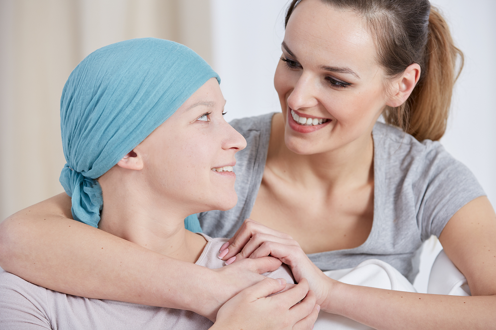 radiotherapy treatment - cancer woman wearing headscarf talking with friend
